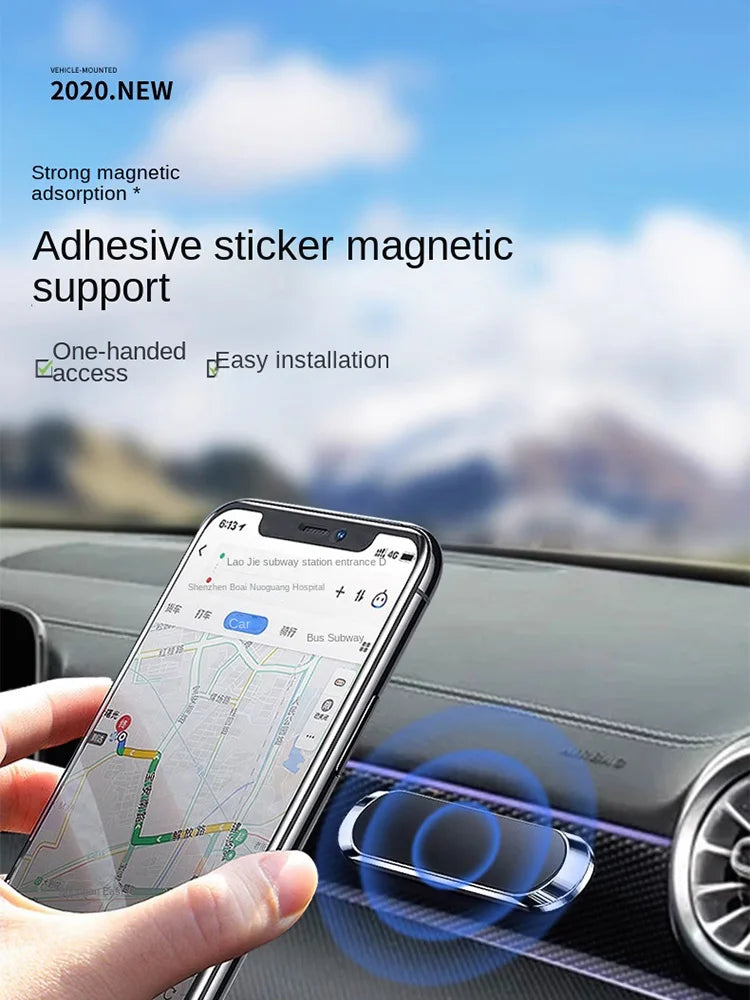 Small, sleek, silver and black magnetic adhesive phone mount attached to a car dashboard with a smartphone held near it.