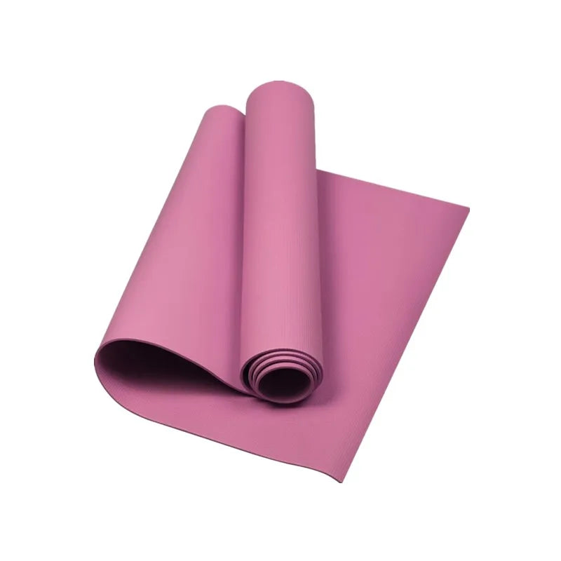 A partially rolled, textured mauve pink yoga mat isolated on a white background.