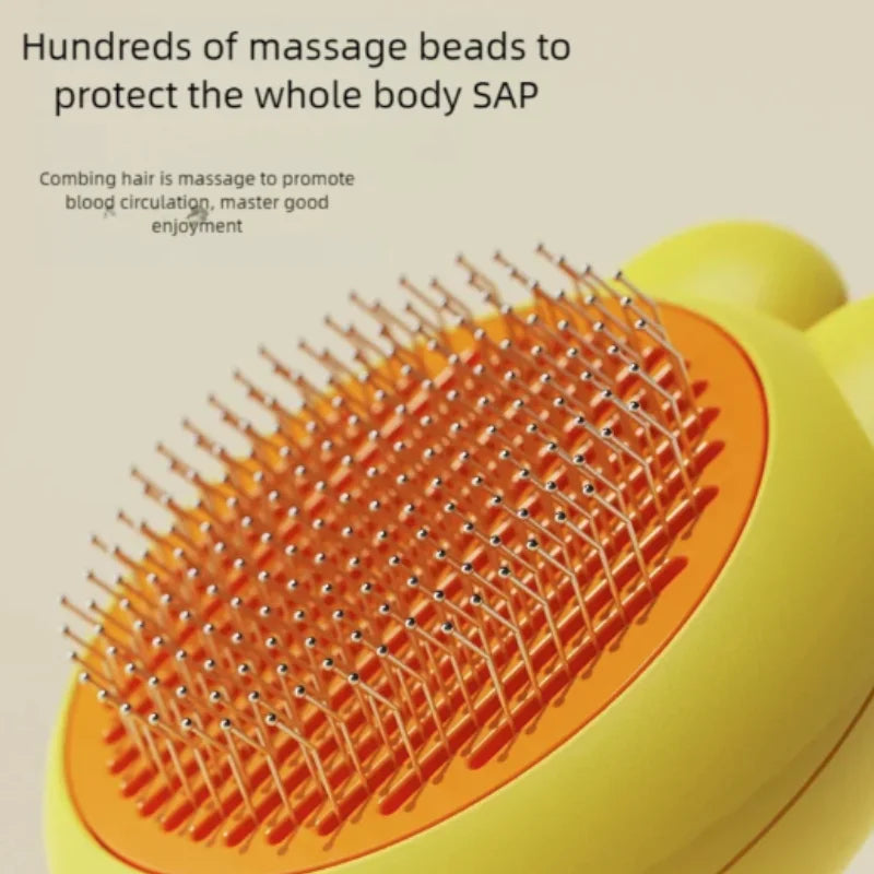Bright yellow pet grooming brush with an orange base and fine metal bristles tipped with protective massage beads.