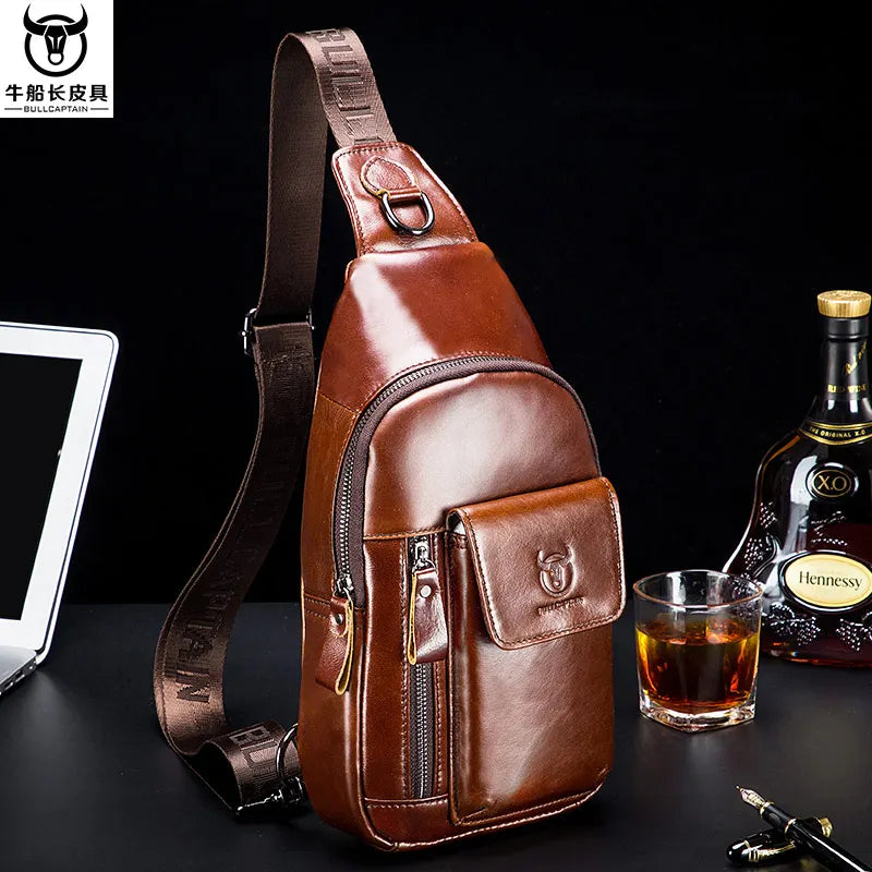 Brown leather multifunction sling bag with an adjustable strap, front zip pocket, and magnetic flap closure.