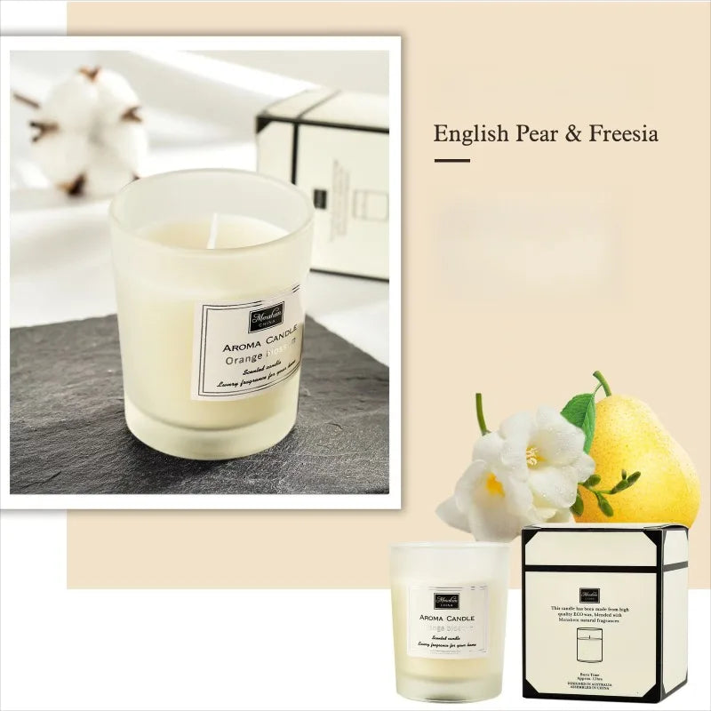 English Pear and Freesia scented candle in a minimalist frosted glass jar, accompanied by its elegant gift box.
