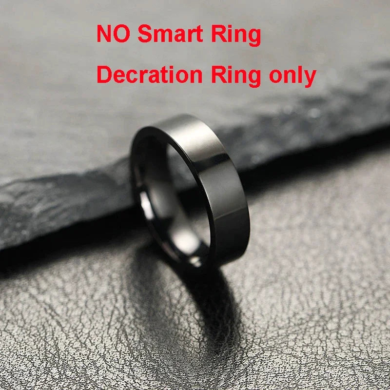 A polished, plain black decorative ring resting on a textured, dark surface. Note: This is not a smart ring.
