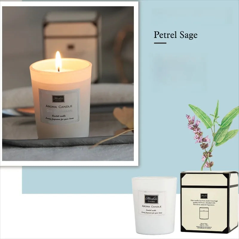 Lit Petrel Sage scented candle in a white glass jar with its matching gift box and a sage plant illustration.