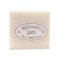 Square block of creamy white rice milk soap with an oval product label.