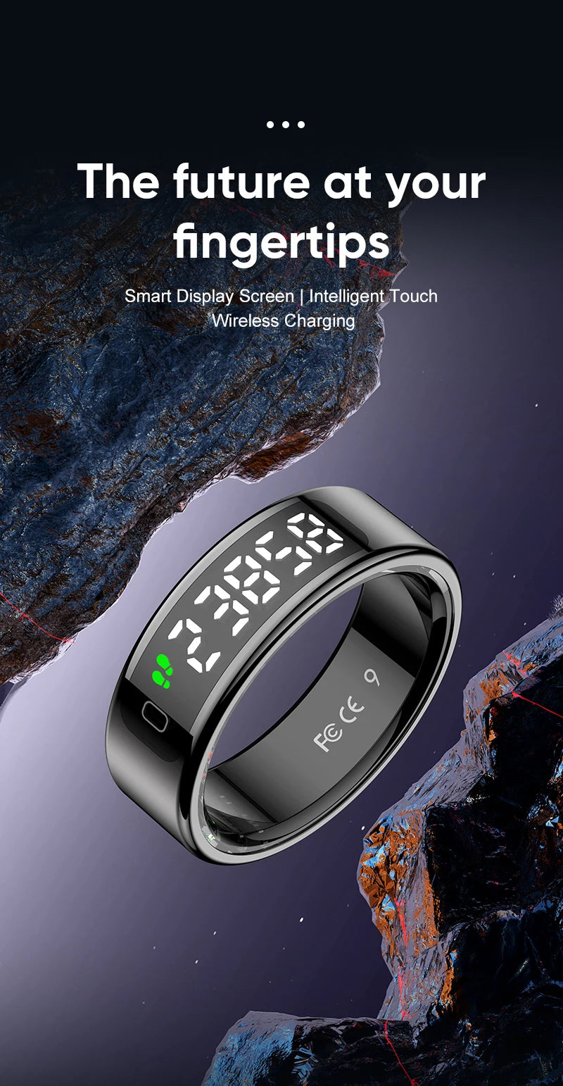 Sleek black smart fitness ring with a digital touch display showing step count, set against a dark rocky background.