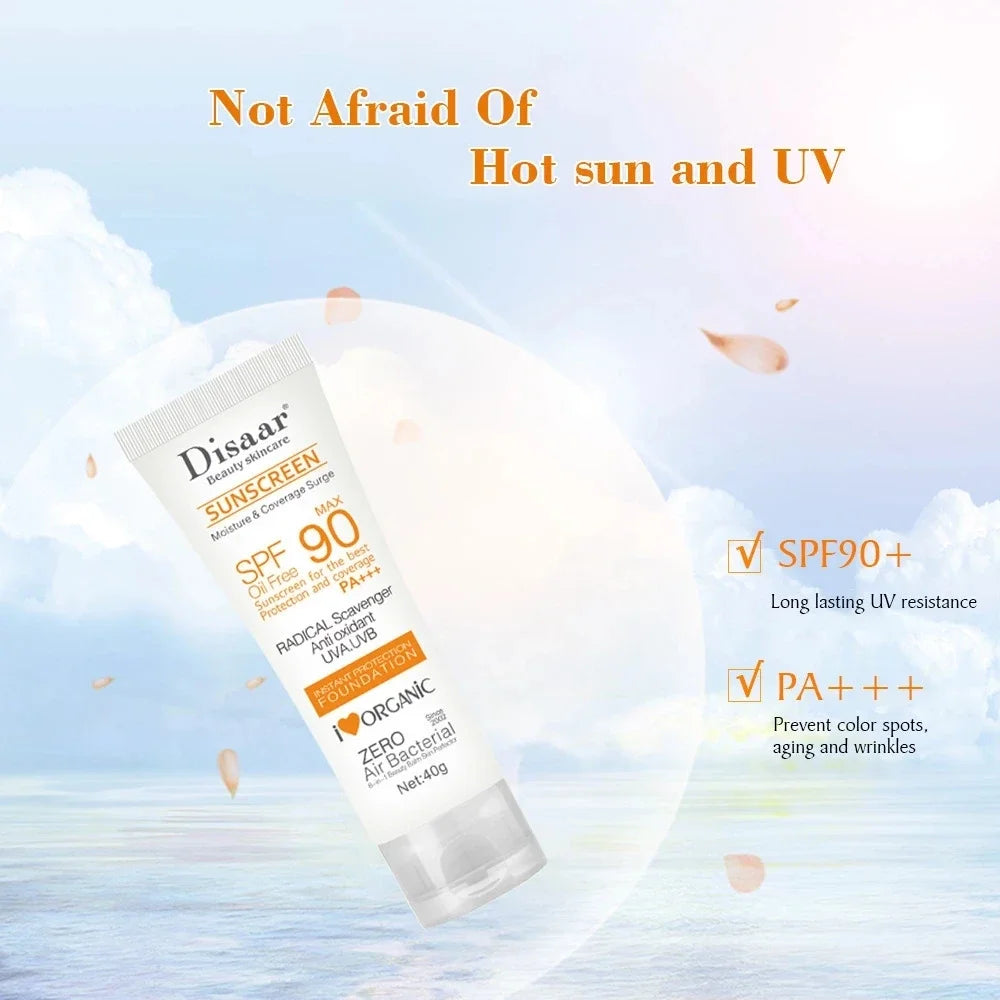 White 40g tube of SPF90+ PA+++ sunscreen, oil-free formula with anti-aging UV protection, against a sunny beach backdrop.