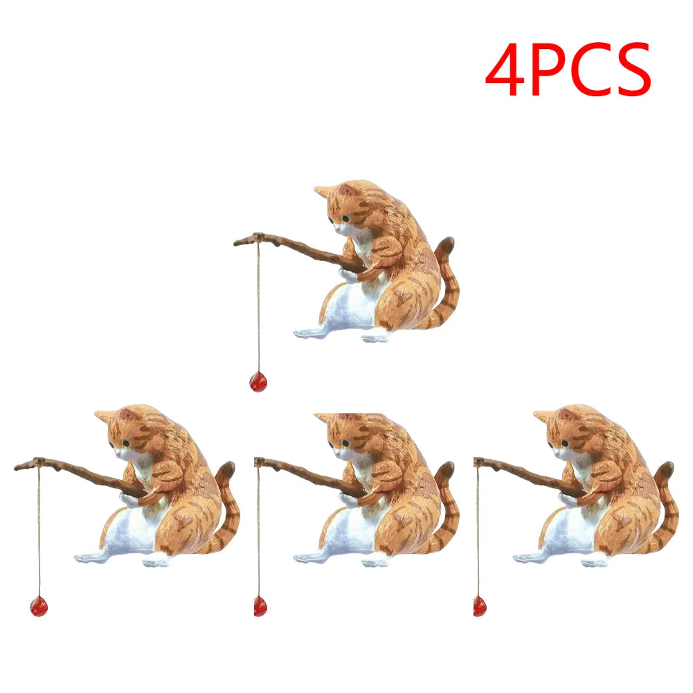 A set of four cute, ginger tabby cat ornaments holding small fishing rods, perfect for aquarium decoration.