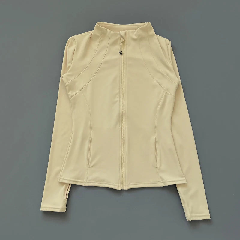 Cream-coloured athletic zip-up jacket with a mock neck, long sleeves, thumb holes, and two front pockets.