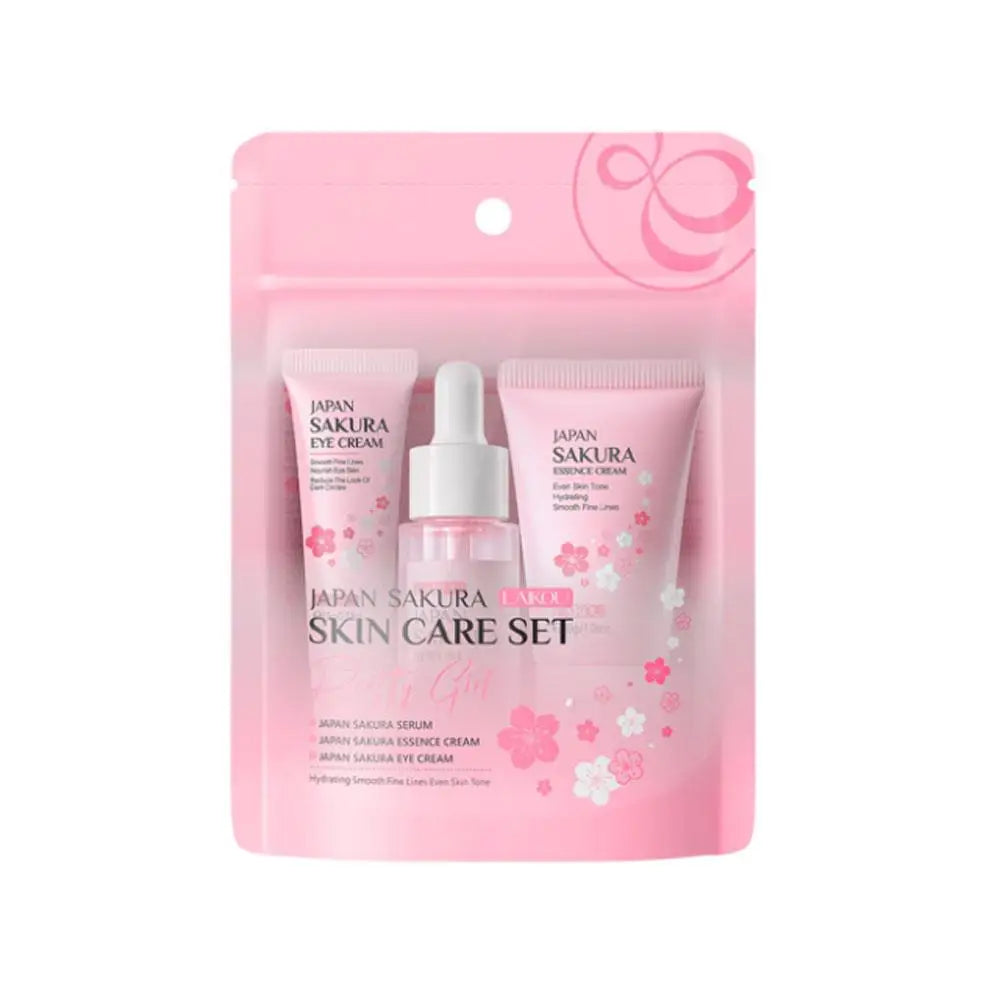 Pink skincare gift set including serum, eye cream, and essence cream in a convenient floral-themed travel pouch.