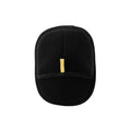 Black oval-shaped exfoliating body mitt with a textured mesh surface and small yellow hanging loop.
