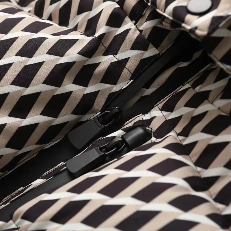 Close-up of a black, beige, and white geometric pattern puffer jacket featuring a dual-zipper closure.