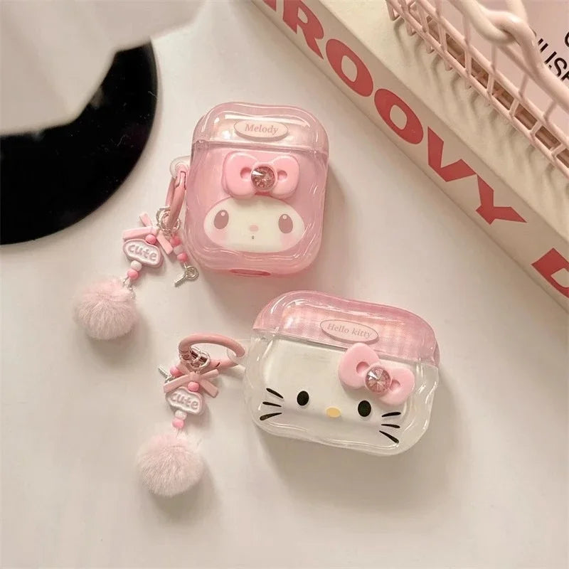 Pink Sanrio-themed clear protective cases for AirPods, featuring My Melody and Hello Kitty designs with pom-pom charms.