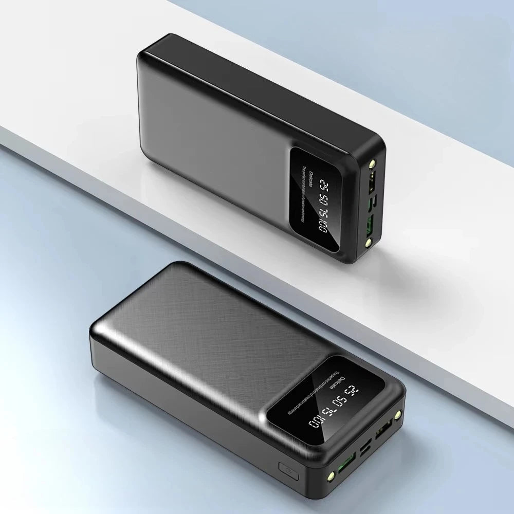 Two sleek, black 50,000mAh portable power banks with a textured finish and a digital LED battery percentage display.