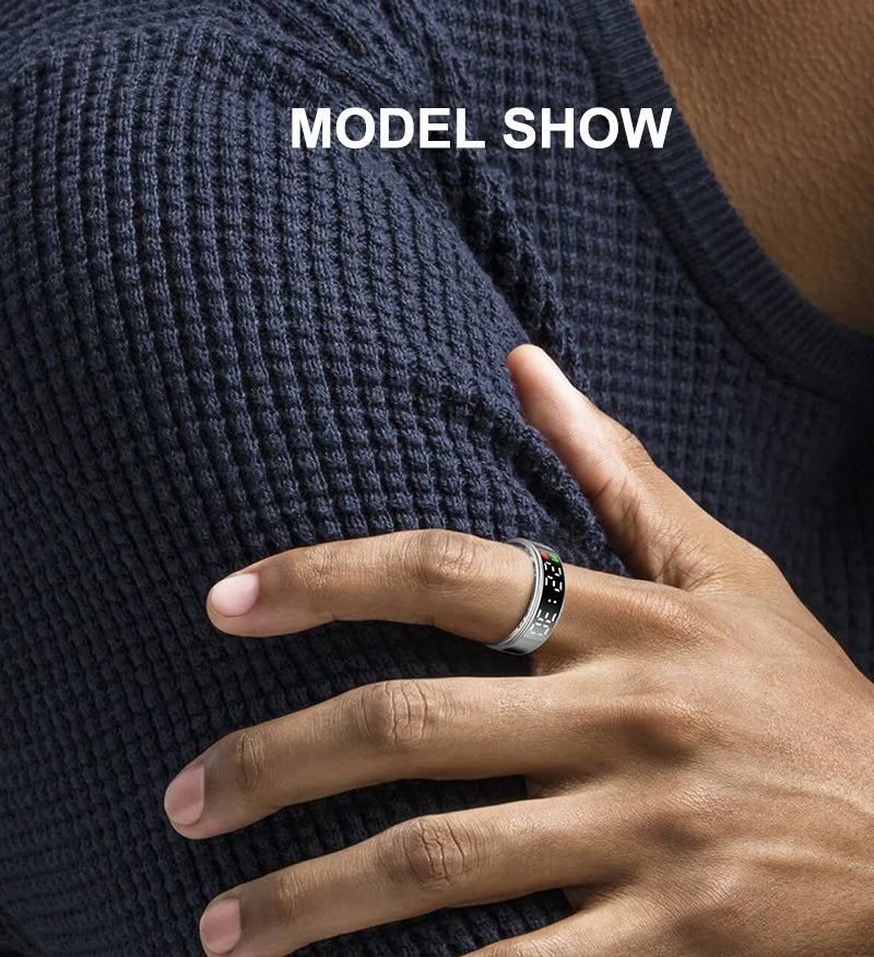 Sleek silver smart health tracker ring worn on a finger, featuring a small digital display screen.