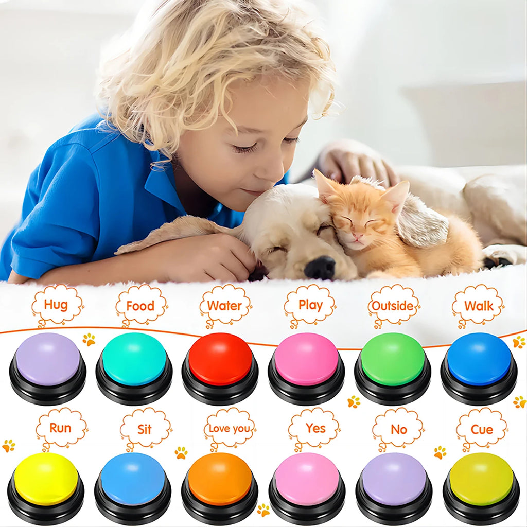 A child cuddles a puppy and kitten behind twelve colourful, recordable dog training buttons with text labels.