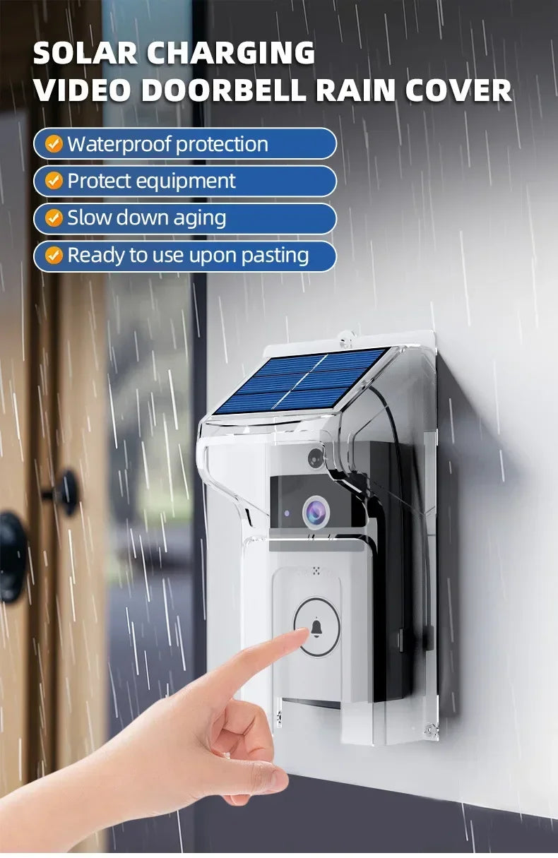 Black and white video doorbell with a solar-panelled clear rain cover, mounted on a wall in the rain.