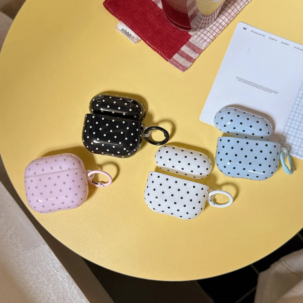 Polka dot protective silicone cases for AirPods Pro with matching keyrings, available in black, blue, pink, and white.