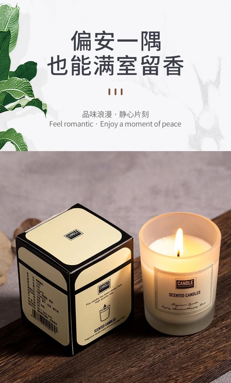 Lit scented candle in a frosted glass holder, displayed next to its elegant cream and black presentation box.