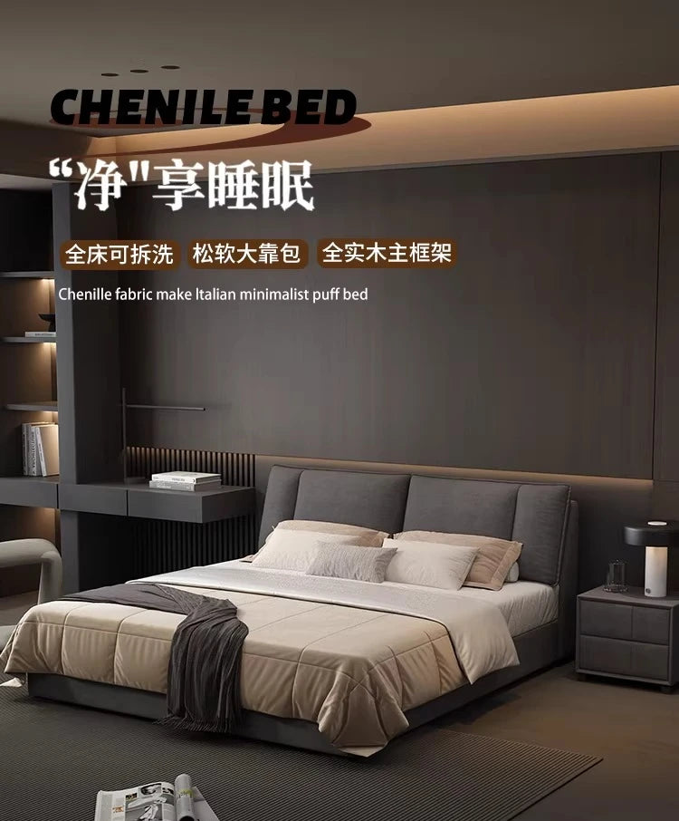 Modern charcoal grey upholstered double bed with a soft, padded headboard and minimalist design in a bedroom setting.