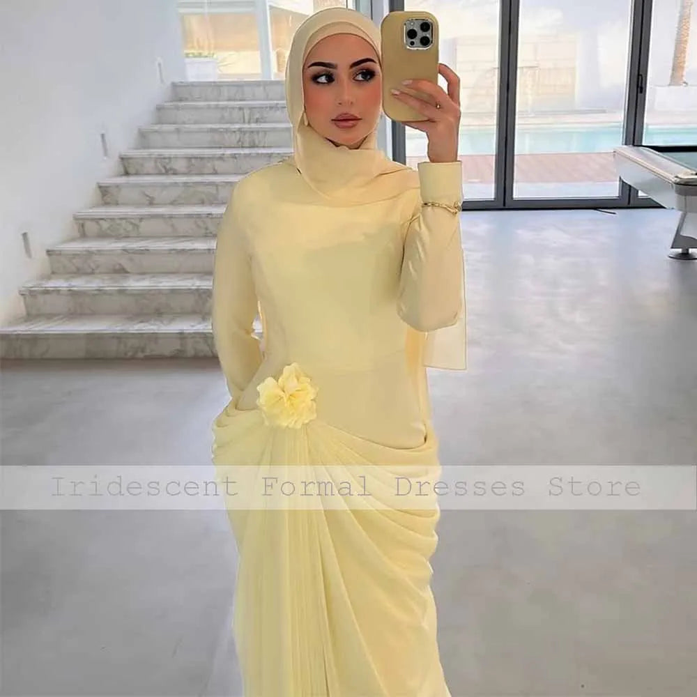 Light yellow high collar long sleeve mermaid evening gown with a 3D flower and pleated skirt.