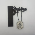Decorative black wall-mounted scroll bracket with a hanging plaque reading "Dark Romance" featuring a skull and books.
