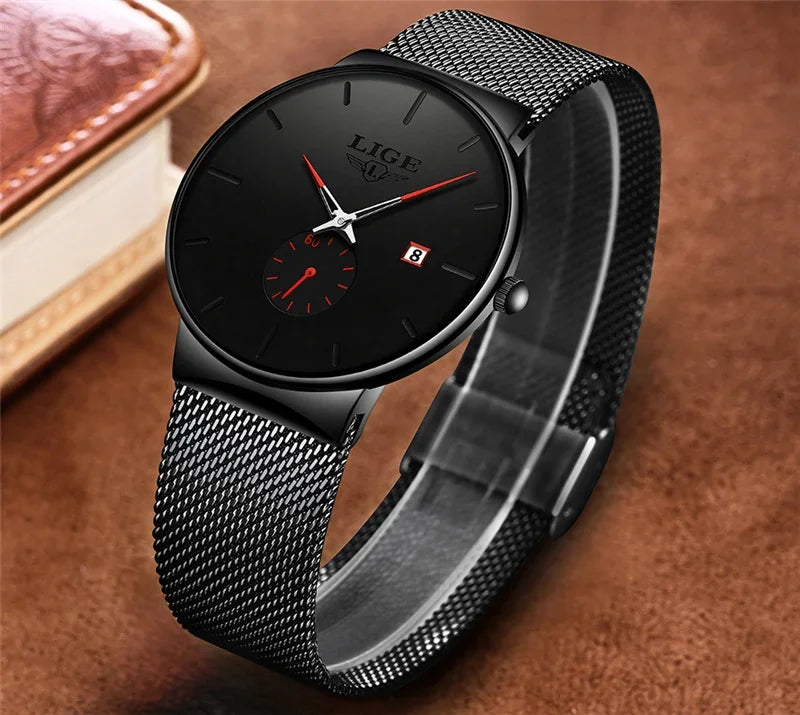 Elegant ultra-thin watch with a black dial, red accents, and a matching black stainless steel mesh strap.