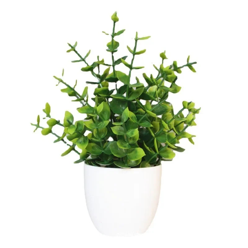 Artificial potted plant with vibrant green, multi-stemmed leaves in a minimalist, matte white rounded pot.