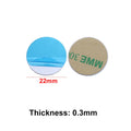 Two 22mm adhesive circular pads with blue peel-off backing and tan adhesive sides. Thickness is 0.3mm.