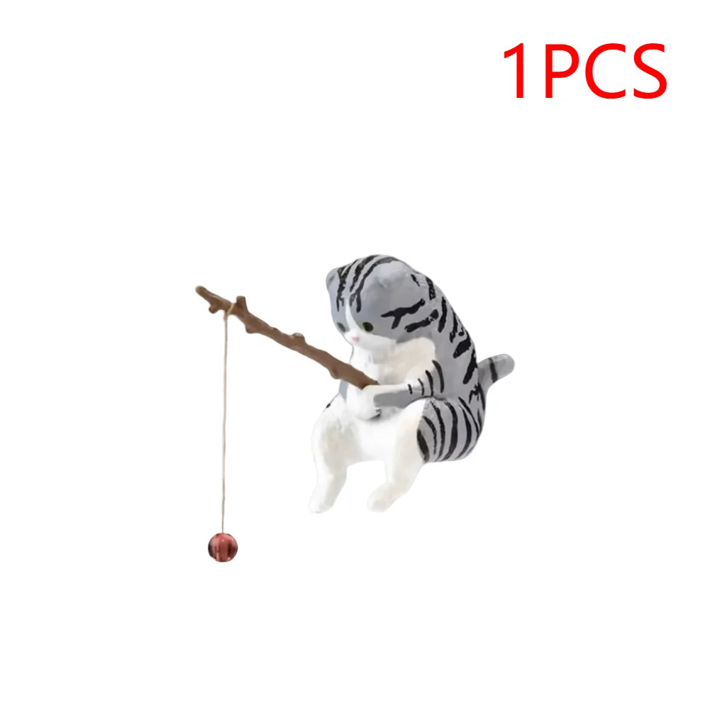 Cute grey and white tabby cat aquarium ornament holding a wooden fishing rod with a small red lure.