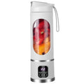White portable electric blender with a clear window showing fruit and a digital display panel on the base.