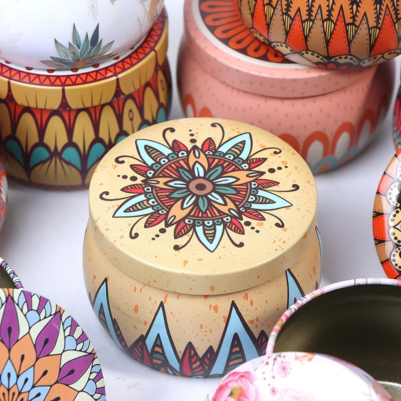 Assorted small round metal tins featuring colourful boho mandala and floral patterns, ideal for candles or storage.