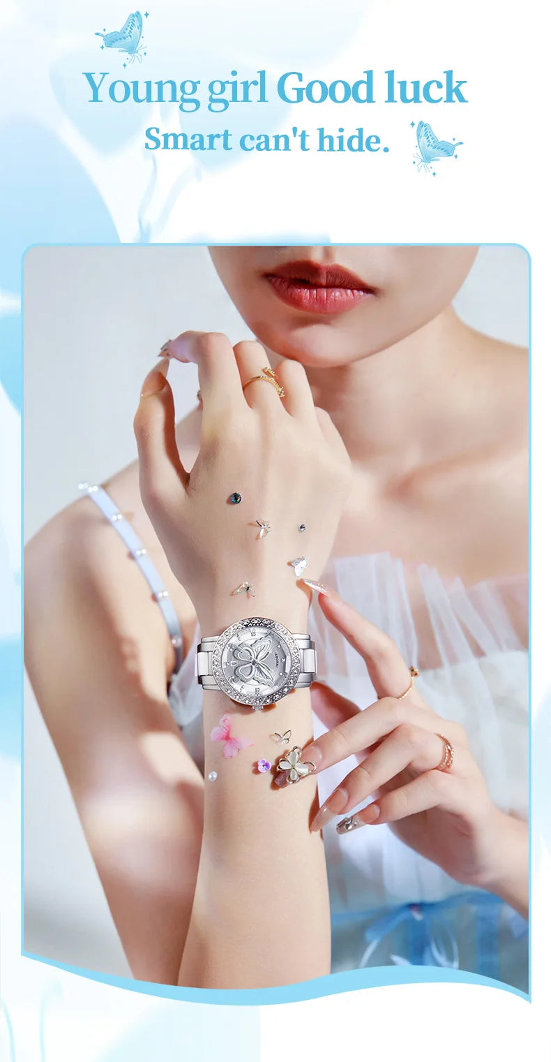 Luxury silver women’s watch with a butterfly-pattern dial and crystal-encrusted bezel, worn on a delicate wrist.