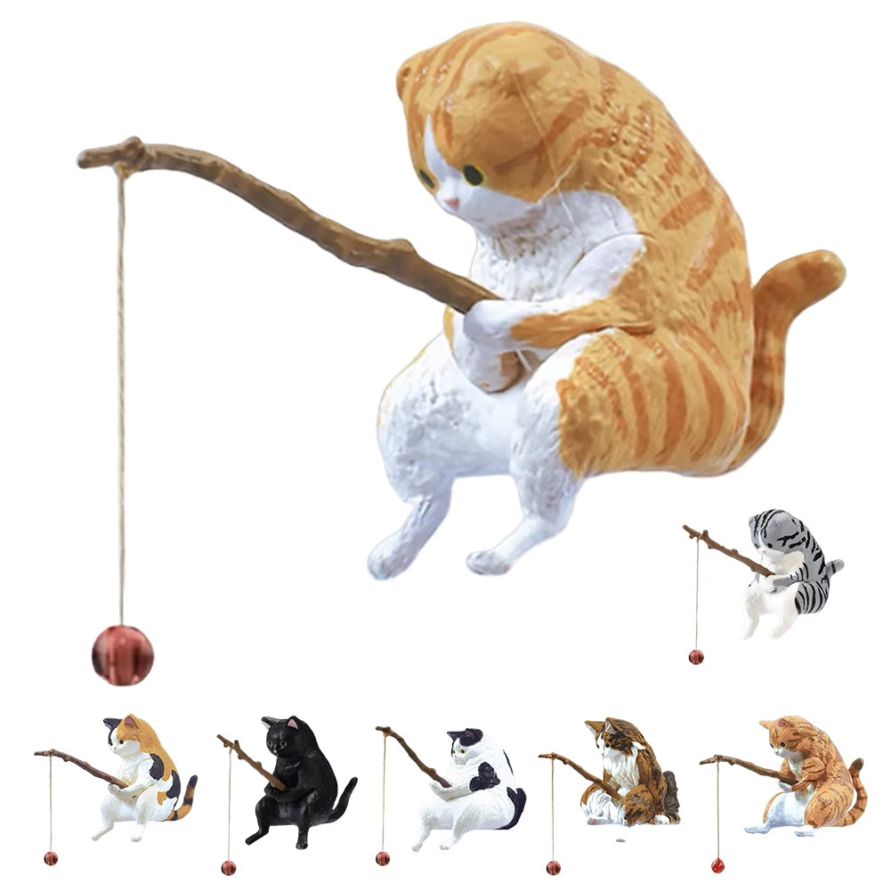 A collection of small cat-shaped aquarium ornaments in various colours, each holding a miniature fishing rod with a bead.