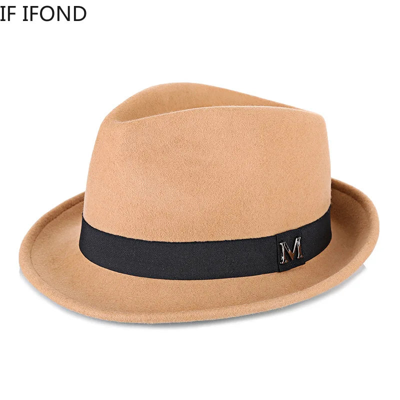 Tan wool felt fedora with a black ribbon band and metallic "M" detail on the side.