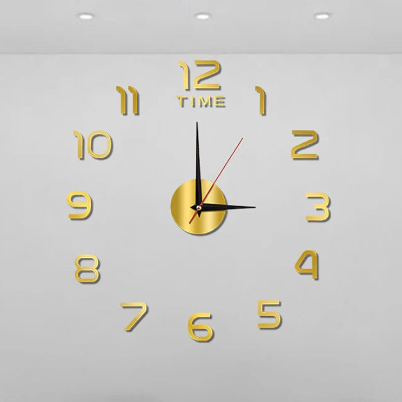 Large, gold acrylic DIY wall clock with 3D numbers and a central mirror-finish dial on a plain grey wall.