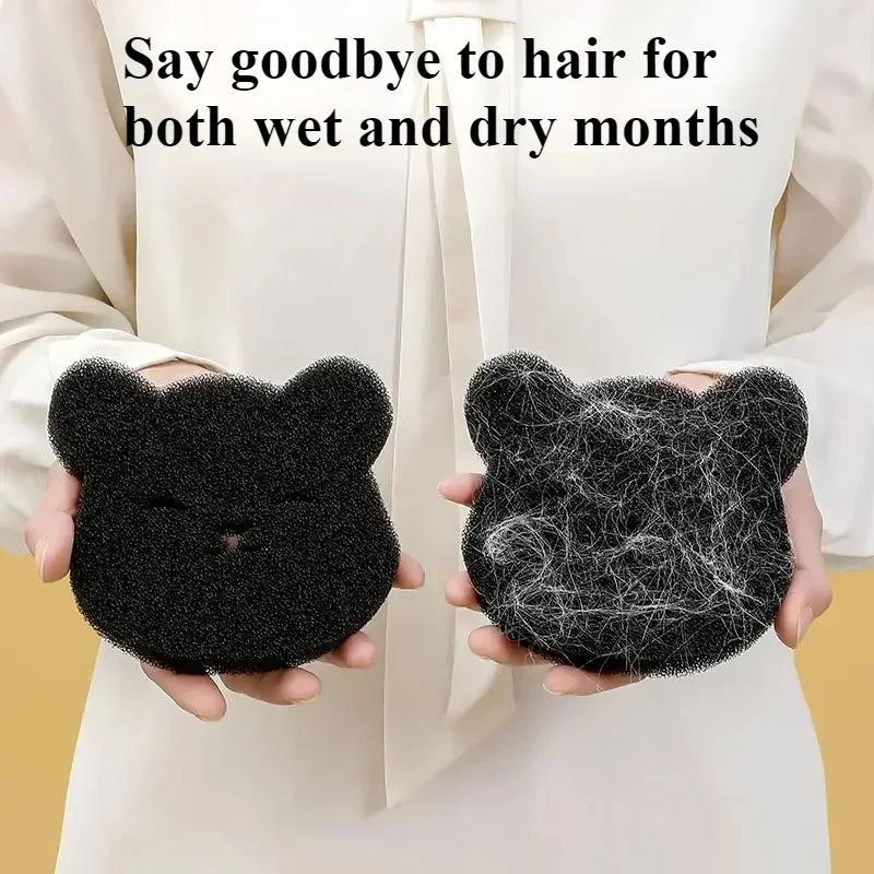 A person holding two black bear-shaped foam sponges, one clean and one covered in collected white pet hair.
