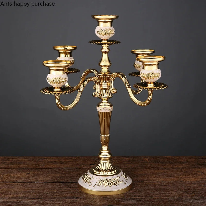 Gold and white European-style five-arm candelabra with ornate floral detailing and curved branches.