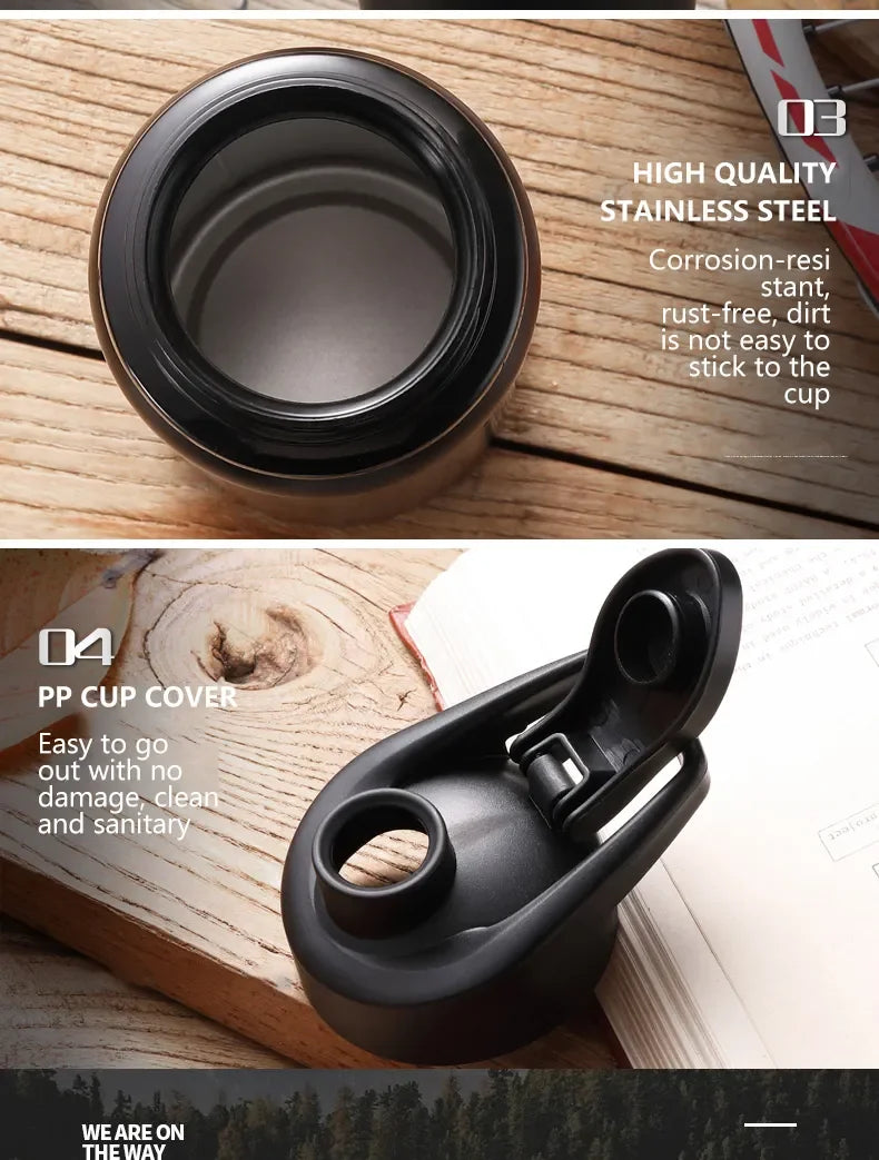 Stainless steel water bottle showing the open rim and black flip-top lid on a wooden background.