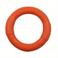 Bright orange, durable EVA foam dog training ring with textured grip sections and embossed dog silhouettes.