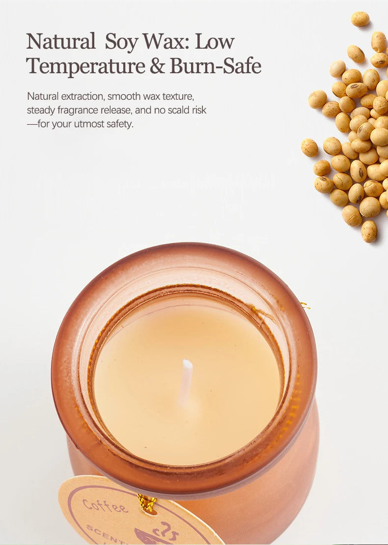 Top-down view of a coffee-scented soy wax candle in an amber glass jar, surrounded by scattered raw soy beans.