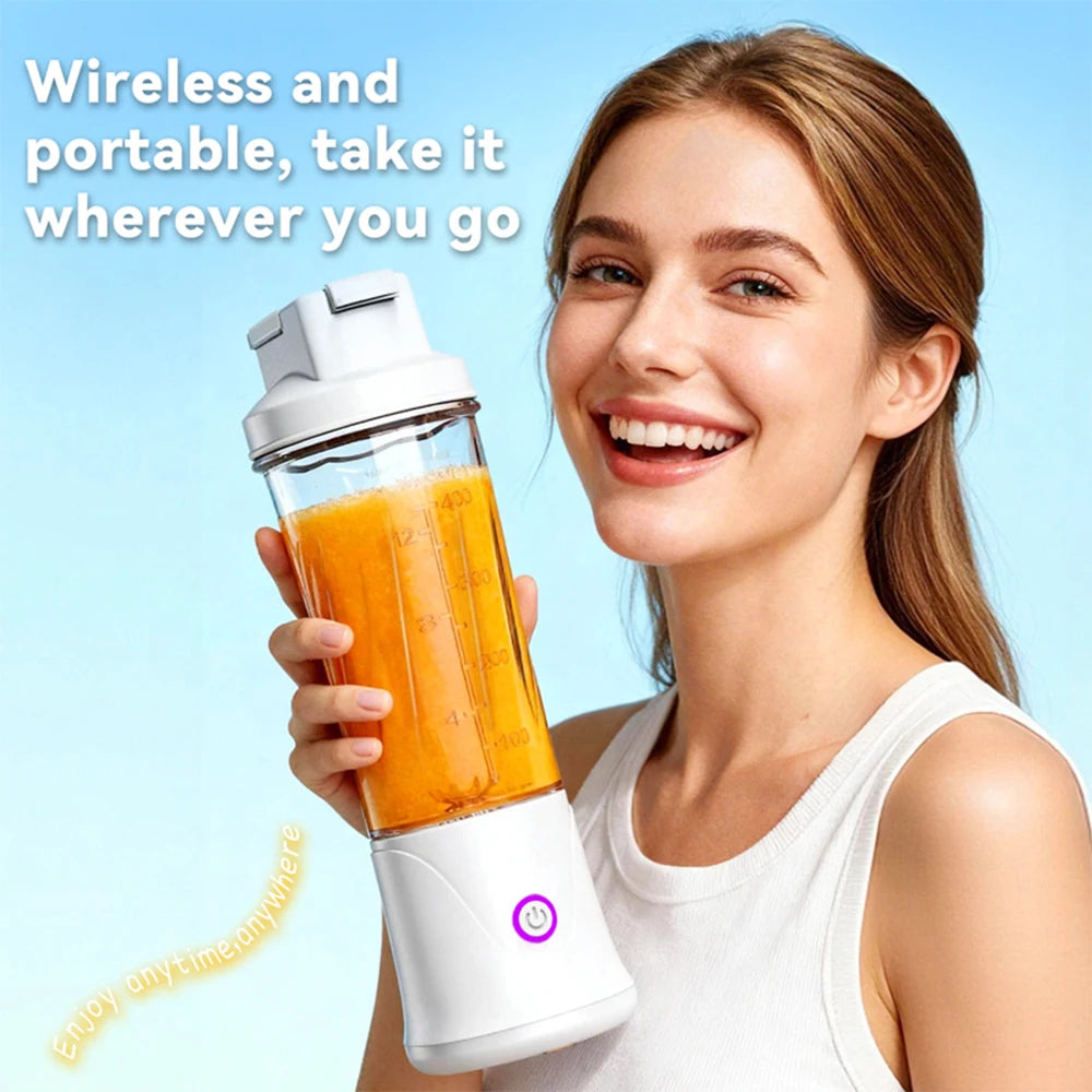 Woman holding a portable white wireless blender filled with orange juice against a blue background.