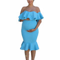 Bright blue maternity midi dress with off-the-shoulder ruffled neckline and flared mermaid hem.