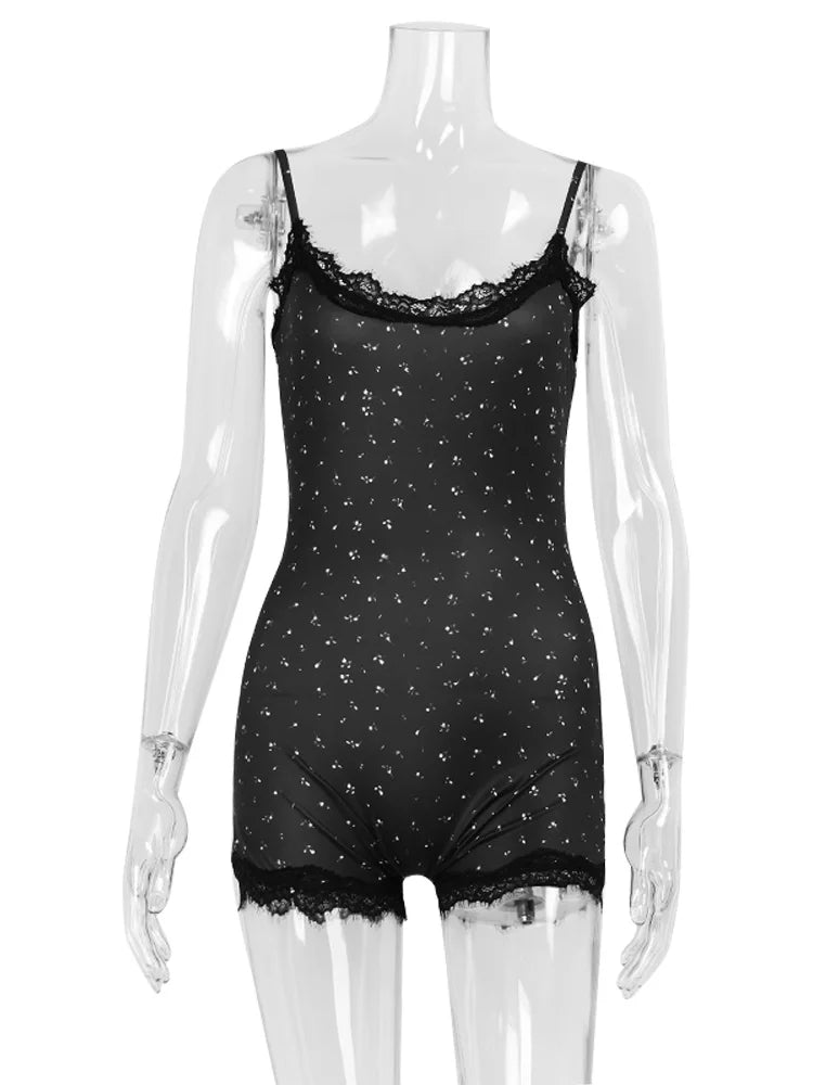 Black sleeveless playsuit with a white print, scoop neck, and black lace trim on the neckline and hem.