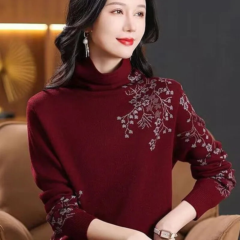 Burgundy turtleneck sweater featuring elegant grey floral embroidery on the shoulder and sleeves.