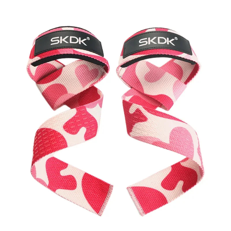 A pair of SKDK weightlifting straps in pink and cream camo print with black branded wrist padding.