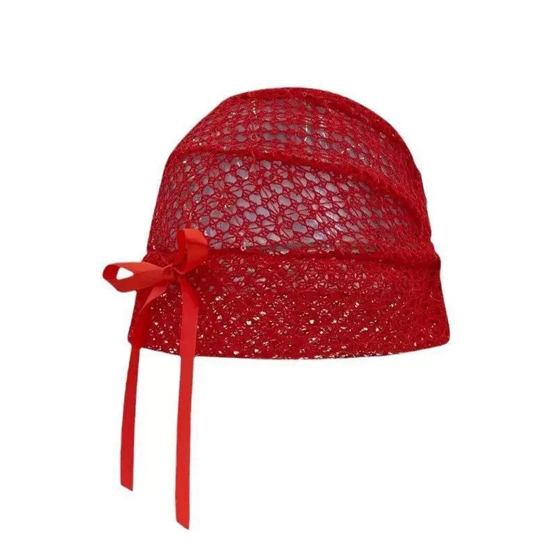 Elegant red lace-knit cloche hat featuring a delicate side ribbon bow.
