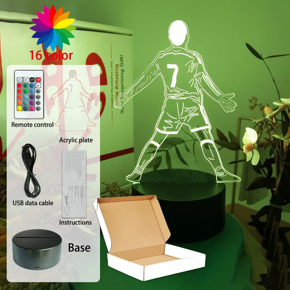 16-colour LED night light featuring a 3D acrylic football player design with remote control, base, and USB cable.