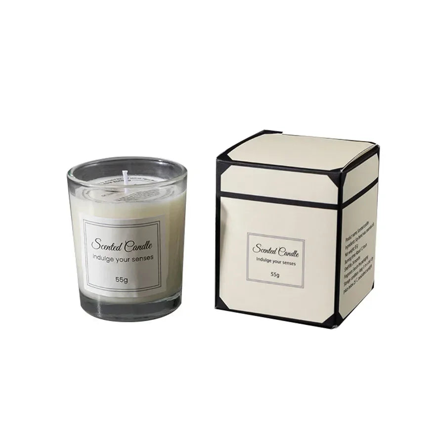 Small 55g white scented candle in a glass jar, accompanied by its matching cream and black gift box.