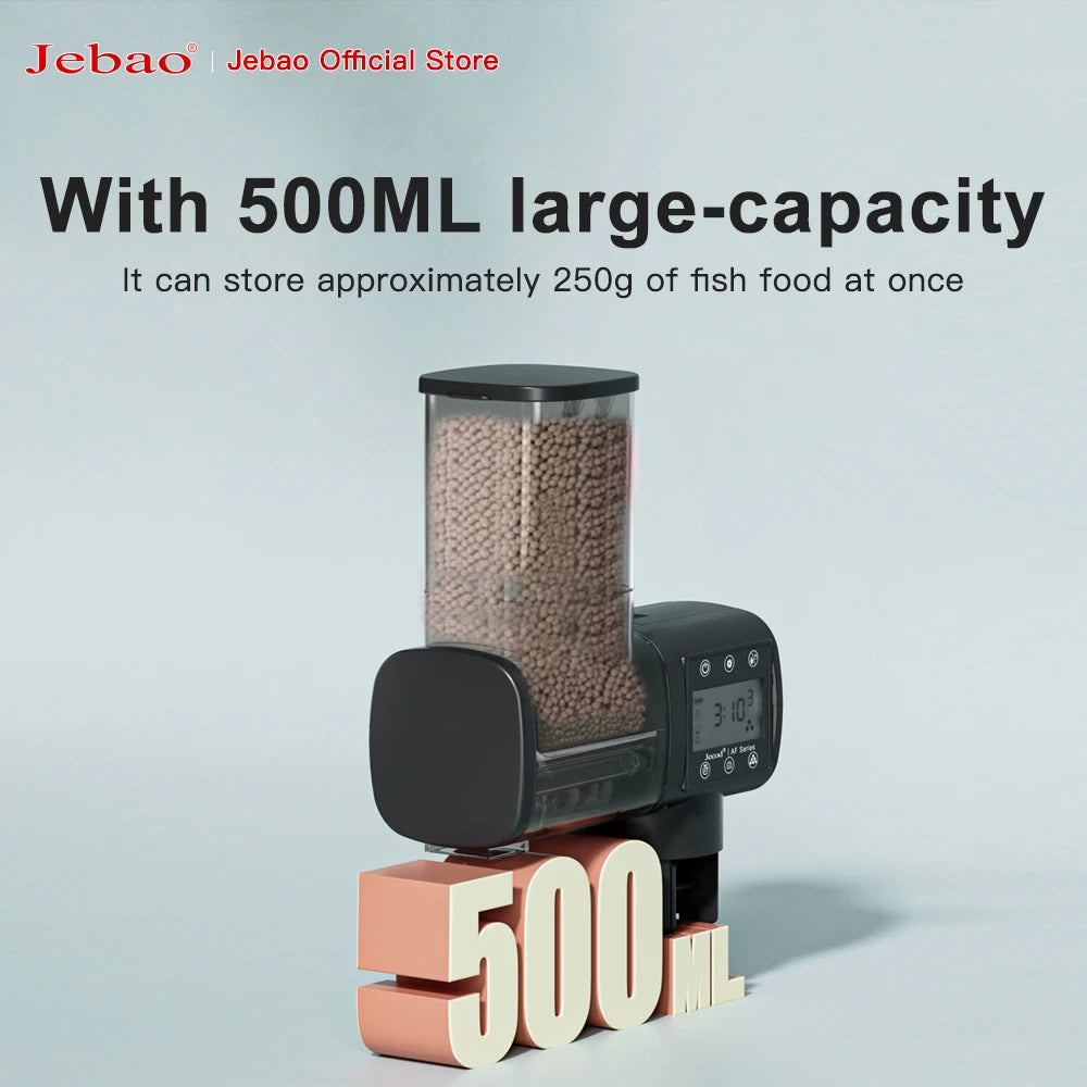 Black automatic fish food dispenser with a clear 500ml container filled with brown pellets and a digital display screen.