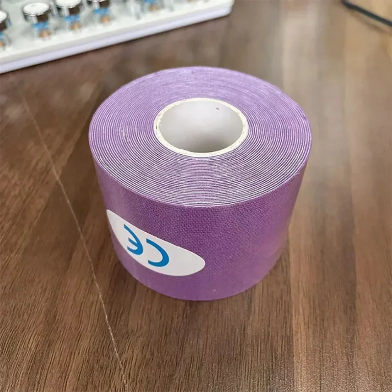 A roll of lilac-coloured kinesiology tape with a CE marked sticker, resting on a wooden surface.